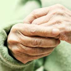 Elder woman's hands suffering from arthritis.