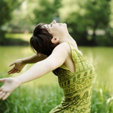 Young woman in in forest happy and relaxed being stress-free.